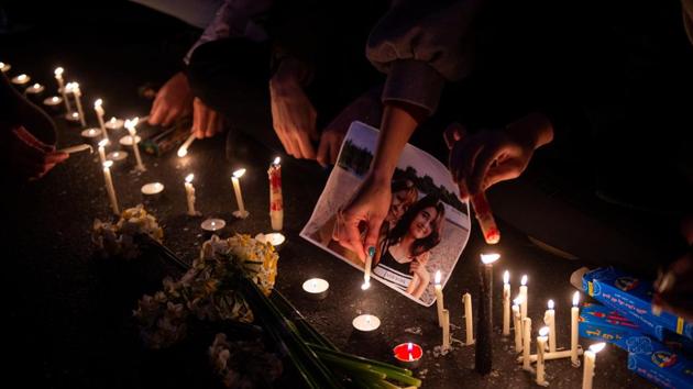 Demonstrators light candles for the victims during a vigil. “They are lying that our enemy is America, our enemy is right here,” dozens of protesters chanted outside a university in Tehran. Scores of demonstrators were also seen gathered in other cities. (Bloomberg)