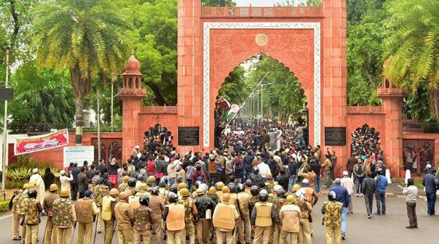 Police personnel stand guard outside Aligarh Muslim University (AMU) as students protest against the passing of Citizenship Amendment Bill, in Aligarh, Friday, Dec. 13, 2019.(PTI file photo)