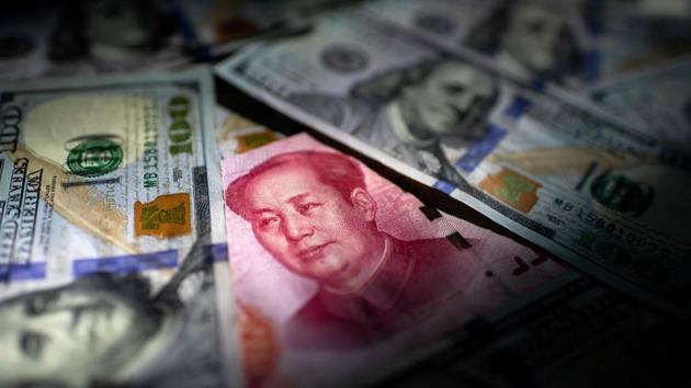 A photo illustration of a Chinese 100 yuan note (C) and US 100 notes. China’s trade surplus with the United States narrowed last year as the world’s two biggest economies exchanged punitive tariffs in a bruising trade war, data showed on Tuesday, just as the two prepared to sign a deal dialling down tensions. (Nicolas Asfouri / AFP) A photo illustration of a Chinese 100 yuan note (C) and US 100 notes. China’s trade surplus with the United States narrowed last year as the world’s two biggest economies exchanged punitive tariffs in a bruising trade war, data showed on Tuesday, just as the two prepared to sign a deal dialling down tensions. (Nicolas Asfouri / AFP)