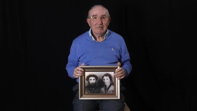 Szmul Icek shows a picture of his parents killed by the Nazis, at his home in Jerusalem. Born in Poland in 1927, he and two brothers survived while their parents and two sisters were killed in the Holocaust, and, in contrast to some survivors, he never returned to the camp after the war and avoids reading books on the subject. (Menahem Kahana / AFP) 
