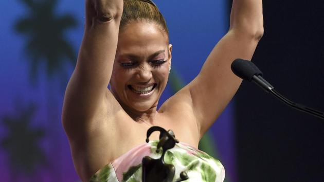 Jennifer Lopez reacts as she accepts the spotlight actress award for her role in Hustlers at the 31st annual Palm Springs International Film Festival Awards Gala.(Chris Pizzello/Invision/AP)