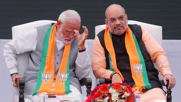 Prime Minister Narendra Modi gestures as BJP chief Amit Shah looks on after releasing their party's election manifesto for the May general election in New Delhi.(REUTERS)