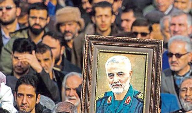 Protesters hold up a photo of Iranian commander Qasem Soleimani during an anti-US rally in Tehran.(Bloomberg)