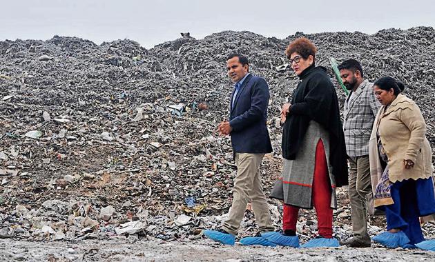 Mayor Raj Bala Malik and MC commissioner KK Yadav at the garbage dumping ground in Dadumajra on Wednesday. They were there to inspect the adjoining garbage processing plant, and came down heavily on its management, putting the blame on them for the city faltering in Swachh Survekshan.(Ravi Kumar/HT)