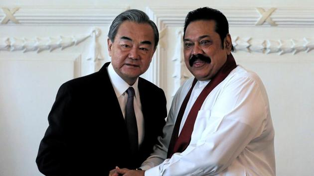 Chinese Foreign Minister Wang Yi shakes hands with Sri Lankan Prime Minister Mahinda Rajapaksa.(Reuters image)