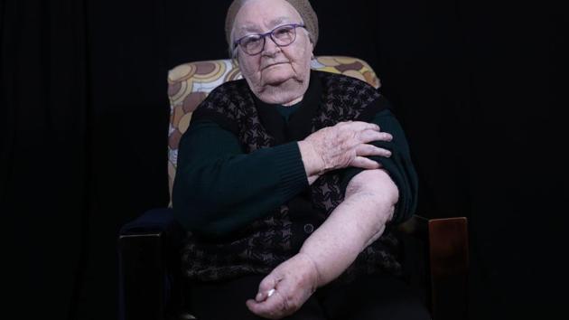 Helena Hirsch shows her arm with the Auschwitz prison number A 20982, at her home in Israel's Beni Brak suburb east of Tel Aviv. Born in Romania in 1928, she moves around slowly with the aid of a walking frame but she maintains her lively spirit, describing herself as a ‘heroine.’ “If I’m alive today, it’s because I am a heroine,” said Hirsch, the sole survivor from her family. (Menahem Kahana / AFP) 