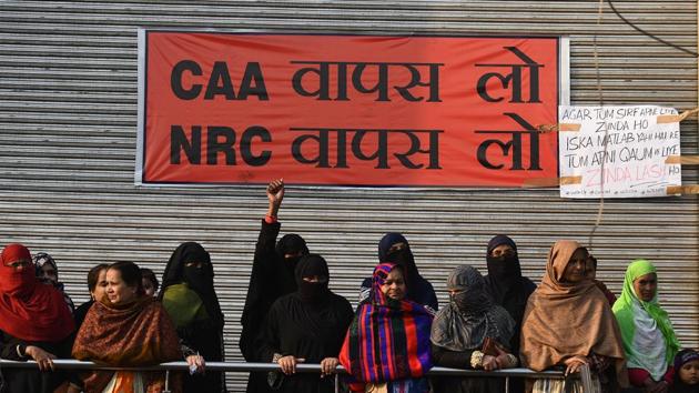 Women are seen with a banner pasted on the shutter of a closed shop during a sit-in protest against the Citizenship Amendment Act (CAA) at Shaheen Bagh. For the past month, several women in Shaheen Bagh have been living two lives—of a protester and a homemaker. They wake up in the morning, finish their chores, and come to the tent at the protest site. (Biplov Bhuyan / HT Photo) Women are seen with a banner pasted on the shutter of a closed shop during a sit-in protest against the Citizenship Amendment Act (CAA) at Shaheen Bagh. For the past month, several women in Shaheen Bagh have been living two lives—of a protester and a homemaker. They wake up in the morning, finish their chores, and come to the tent at the protest site. (Biplov Bhuyan / HT Photo)