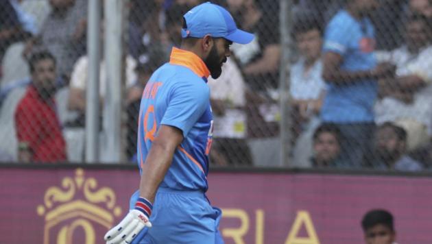 India's Virat Kohli walks back after losing his wicket(AP)