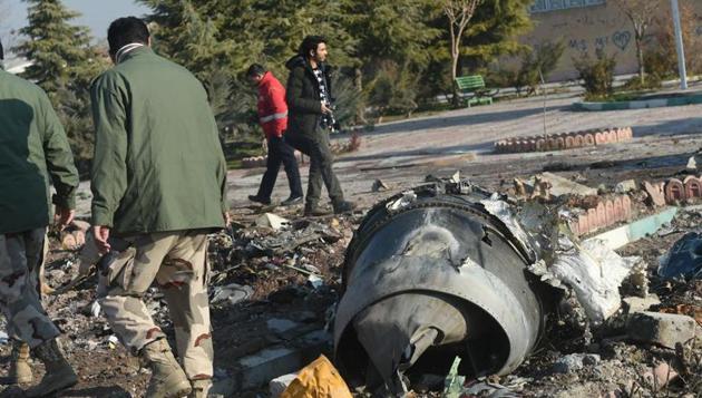 Rescue workers search the wreckage of a Boeing Co. 737-800 aircraft, operated by Ukraine International Airlines, which crashed shortly after takeoff near Shahedshahr, Iran, on January 8, 2020.(Bloomberg File Photo)