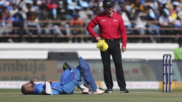 India's Shikhar Dhawan lies on the ground after being hit by a ball during the second one-day international cricket match between India and Australia in Rajkot, India, Friday, Jan. 17, 2020.(AP)