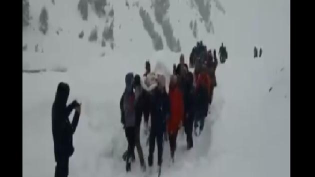 Locals accompanied the police team walking behind them in a line till they reached the hospital.(Twitter/@ANI)