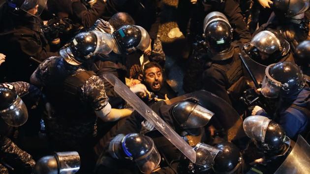 Riot police arrest an anti-government demonstrator who was protesting outside the police headquarters, demanding the release of those taken into custody the night before in Beirut. On Friday, Lebanese security forces had released most of the more than 100 protesters arrested after two nights of violent encounters between police and demonstrators. (Hussein Malla/AP) Riot police arrest an anti-government demonstrator who was protesting outside the police headquarters, demanding the release of those taken into custody the night before in Beirut. On Friday, Lebanese security forces had released most of the more than 100 protesters arrested after two nights of violent encounters between police and demonstrators. (Hussein Malla/AP)