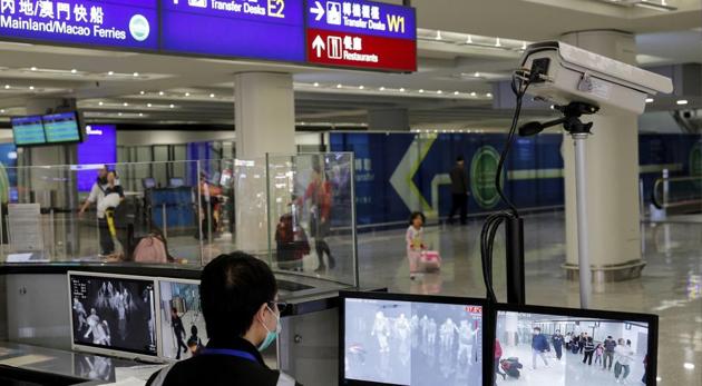 A health surveillance officer monitors passengers arriving at the Hong Kong International airport in Hong Kong following the ourbreak of coronavirus in China’s Wuhan. (AP) A health surveillance officer monitors passengers arriving at the Hong Kong International airport in Hong Kong following the ourbreak of coronavirus in China’s Wuhan. (AP)
