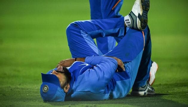 India's Rohit Sharma reacts after being hurt while fielding a ball during the second one day international (ODI) cricket match of a three-match series between India and Australia at Saurashtra Cricket Association Stadium in Rajkot on January 17, 2020.(AFP)