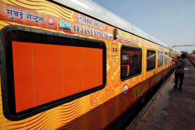 A man cleans the exteriors of a coach of India's first private train Tejas Express in Ahmedabad in this file photo.(Reuters)