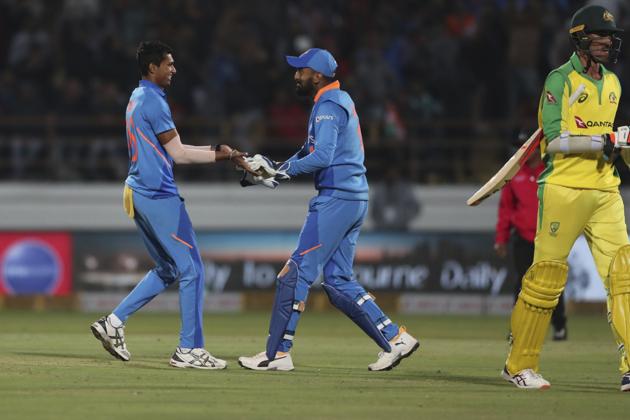 India's Navdeep Saini, left, and Lokesh Rahul celebrate the dismissal.(AP)