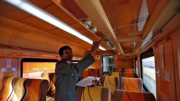 An official shows an overhead panel inside a coach during a media tour. “The train will start its journey at Ahmedabad in the morning at 6.40 am and will reach Mumbai Central at 1.10pm,” the railways said, adding that the train will leave Mumbai Central at 3:40pm for the return journey and will reach Ahmedabad at 9:55pm. (Amit Dave/REUTERS)