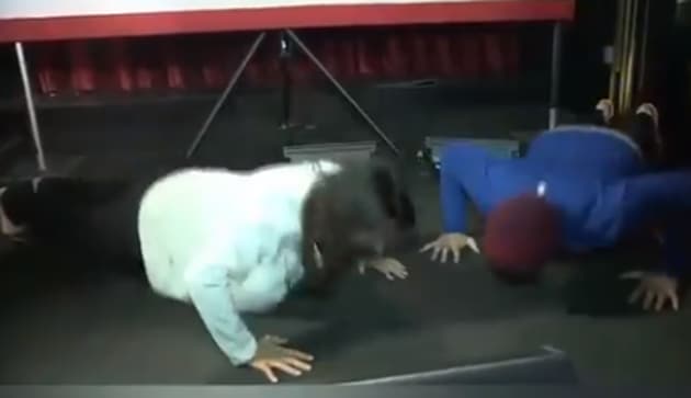 Video posted on Gabbard’s Twitter feed Friday shows them going head to head for nine push-ups before the supporter rolls over in apparent defeat.(Twitter/ Tulsi Gabbard)