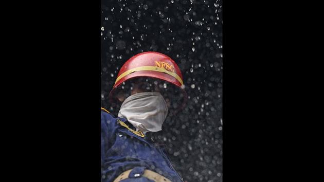 A firefighter is seen at work in a footwear manufacturing unit at Lawrence Road in New Delhi. (Sanchit Khanna/HT Photo) A firefighter is seen at work in a footwear manufacturing unit at Lawrence Road in New Delhi. (Sanchit Khanna/HT Photo)
