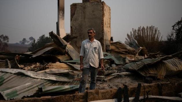 “There has been so much help and support. Everybody looks after each other. There are so many good people here,” said Philippe Ravanel, a Swiss blacksmith, standing in the rubble of a 150-year-old home that he bought in 2006, of which only the fireplace remains. (Alkis Konstantinidis/REUTERS)
