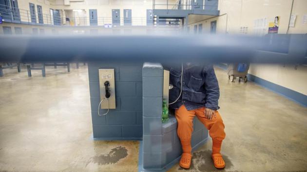 A detainee talks on the phone. It’s difficult for detained immigrants to see or speak to lawyers who live far away, they have no access to email or fax, and the phones sometimes don’t work or are expensive, attorney Erin Argueta told AP. Communications are done by mail, which slows the process of collecting documentation, filling out forms in English and getting documents translated and notarised. (David Goldman / AP)