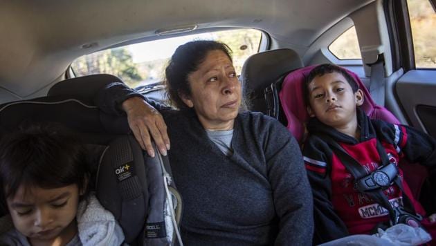Maria Campos in the back seat of a car with her grandchildren, her eyes welling with tears as the immigration centre comes into view. The seven-hour drive from North Carolina to the Stewart Detention Centre in Georgia has become all too familiar. One of her sons was held here before being deported back to Mexico last year, leaving behind his wife and children, who accompany Campos now. (David Goldman / AP)