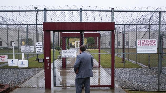 Visitors to the immigration court pass through two sliding gates set into chain-link fencing topped by loops of razor wire, the first gate closing behind them before the second opens. “I think that walking into that environment reinforces the desire to give hope to people and get them free to be with their families,” said Southeast Immigrant Freedom Initiative attorney Matt Boles, who lives full time in Lumpkin. (David Goldman / AP)