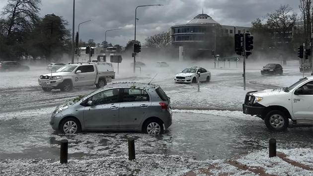 Hail covers vehicles in an intersection in Canberra. Violent hail storms pelted the capital Canberra on Monday, with footage showing the storm ripping branches off trees. Emergency services warned people there to “move cars undercover and away from trees and power lines”. The bureau of meteorology told people in New South Wales, including Sydney, to brace for the approaching storm. (Tom Swann / The Australia Institute via AP)