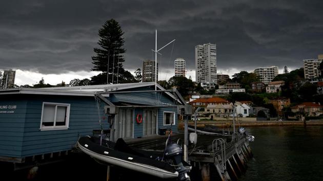 Storm clouds gather over Darling Point in Sydney. The wet weather has brought a reprieve for many fire grounds along the east coast, but authorities remain on high alert, warning that the bushfire season still has weeks to run. Experts expect Australia to lose billions of dollars in tourism revenue as a result of the fires. (Peter Parks / AFP)