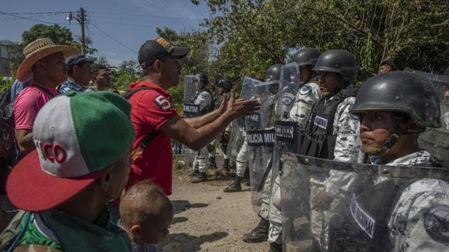 When Mexican officials denied free entry passage, the migrants went down to the Suchiate River where hundreds forded its shallow waters and soon faced guardsmen.(Bloomberg Image)