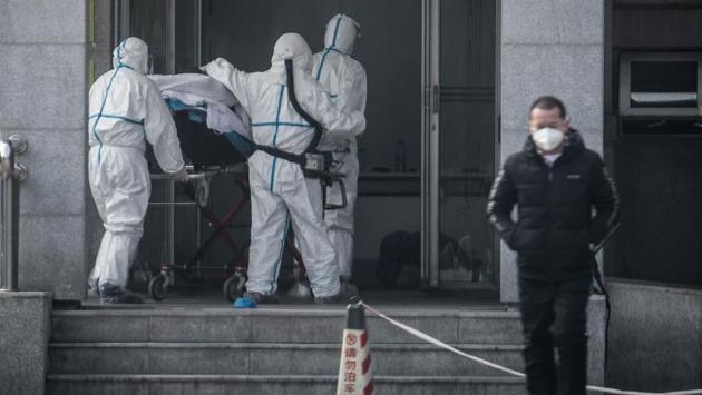 Medical staff members carrying a patient into the Jinyintan hospital, where patients infected with the virus are being treated, in Wuhan. The scare has brought back bad memories of Severe Acute Respiratory Syndrome (SARS), another coronavirus that broke out in China in 2002-2003, resulting in the death of nearly 800 people in global pandemic. (AFP)