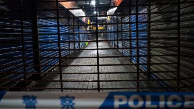 The Wuhan Hygiene Emergency Response Team conducts searches at Huanan Seafood Wholesale Market. The first cases identified late last month were among people connected to the market. The first patients were suspected to have contracted the virus from animals, but human-to-human transmission was confirmed late Monday. (Noel Celis / AFP)