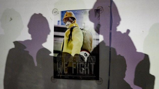 Shadows cast by action figures onto a poster. At one shop in Wanchai district, the owner has created an action-packed diorama of a clash outside a subway station, complete with ranks of riot police and protesters smashing up a taxi. “People play with toys in pursuit of happiness, especially during hard times,” the shop owner told AFP, asking for anonymity fearing reprisals in the febrile political atmosphere. (Philip Fong / AFP) 