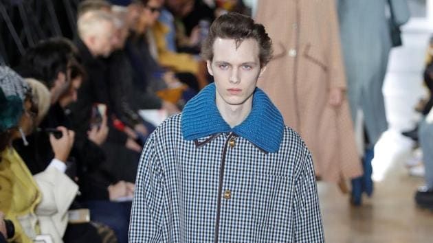 A model presents a creation by designer Bruno Sialelli as part of his Fall/Winter 2020/2021 collection show for fashion house Lanvin during Men's Fashion Week.   (REUTERS) 