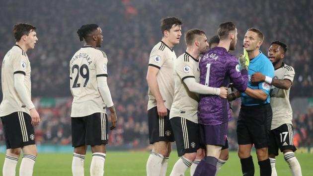 Manchester United's David de Gea is held back by Luke Shaw as he remonstrates with referee Craig Pawson.(Action Images via Reuters)