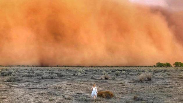 A child runs towards a dust storm in Mullengudgery in New South Wales, Australia. Thunderstorms and giant hail battered parts of Australia’s east coast on Monday after “apocalyptic” dust storms swept across drought-stricken areas, as extreme weather patterns collided in the bushfire fatigued country. (Courtesy of Marcia Macmillan / AFP)