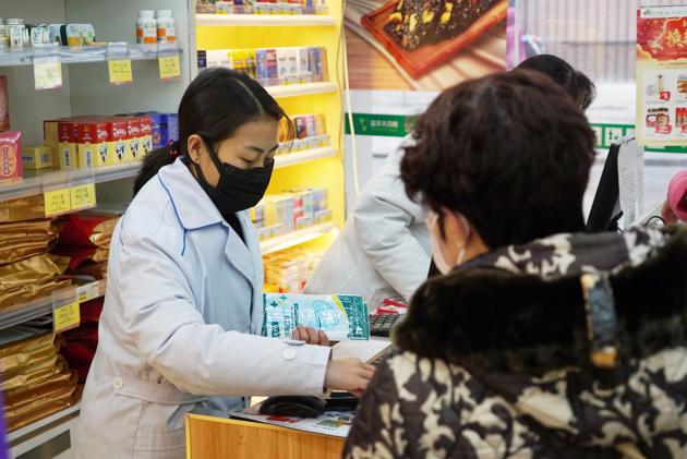 Staff sell masks at a Yifeng Pharmacy in Wuhan.(AP)