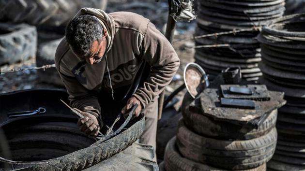 “We cut the tyres here and pull out material including wire rings, which are collected by steel and iron factories to be recycled,” he said. “Tyre rubber is often chopped into small pieces to be used by cement factories as an energy source” -- an alternative to low-grade mazut fuel oil. Other parts are recycled into mulch for playgrounds, he added. (Khaled Desouki / AFP) “We cut the tyres here and pull out material including wire rings, which are collected by steel and iron factories to be recycled,” he said. “Tyre rubber is often chopped into small pieces to be used by cement factories as an energy source” -- an alternative to low-grade mazut fuel oil. Other parts are recycled into mulch for playgrounds, he added. (Khaled Desouki / AFP)