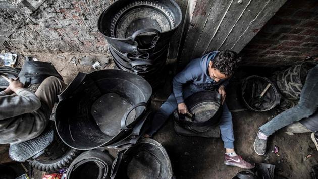 Labourers create rubber baskets from recycled tyre components. “We cut the tyre in half, then we split its inner layers using a winch, before shaping them into baskets and hammering nails around the edges to make them hold,” Azab told AFP. The heavy-duty baskets are often used by farmers, gardeners and labourers, he said. (Khaled Desouki / AFP) Labourers create rubber baskets from recycled tyre components. “We cut the tyre in half, then we split its inner layers using a winch, before shaping them into baskets and hammering nails around the edges to make them hold,” Azab told AFP. The heavy-duty baskets are often used by farmers, gardeners and labourers, he said. (Khaled Desouki / AFP)