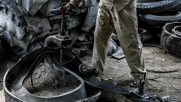 A labourer deconstructs a tyre. Mohamed said his work has grown unstable over the years, especially since the 2011 uprising that unseated long-time dictator Hosni Mubara and triggered years of political and economic turmoil. “There are days with plenty of work and others with little to none,” he said. (Khaled Desouki / AFP) A labourer deconstructs a tyre. Mohamed said his work has grown unstable over the years, especially since the 2011 uprising that unseated long-time dictator Hosni Mubara and triggered years of political and economic turmoil. “There are days with plenty of work and others with little to none,” he said. (Khaled Desouki / AFP)