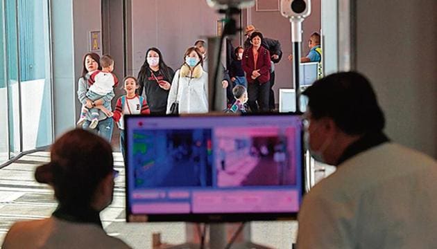 Health officers screen passengers arriving from China at Changi International airport in Singapore on Wednesday (AFP) Health officers screen passengers arriving from China at Changi International airport in Singapore on Wednesday (AFP)