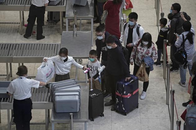 Passengers cross the security check at the departure hall of the high speed train station in Hong Kong.(AP)