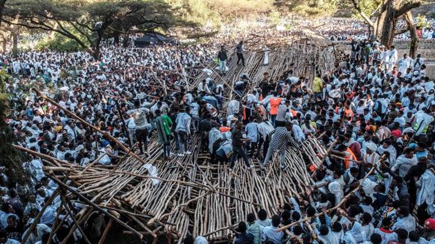 A crowd removes scaffoldings from a structure that collapsed, trapping and injuring dozens of people, during Timkat in Gondar. The holiday, which commemorates the baptism of Jesus in the River Jordan, was marred this year by the collapse of a wooden seating structure during a pivotal ceremony, an accident that left at least 10 people dead. (Eduardo Soteras / AFP) A crowd removes scaffoldings from a structure that collapsed, trapping and injuring dozens of people, during Timkat in Gondar. The holiday, which commemorates the baptism of Jesus in the River Jordan, was marred this year by the collapse of a wooden seating structure during a pivotal ceremony, an accident that left at least 10 people dead. (Eduardo Soteras / AFP)