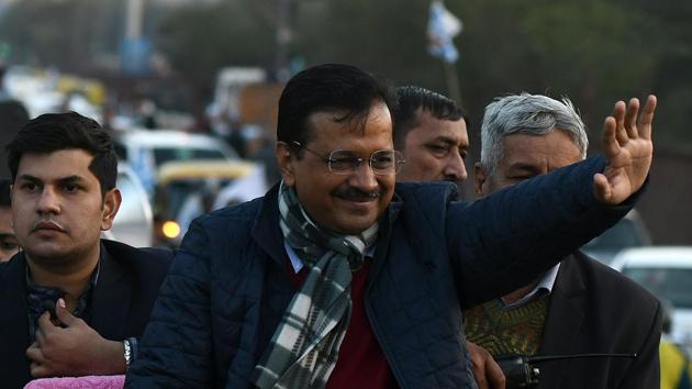 Delhi Chief Minister Arvind Kejriwal waves during a roadshow at Okhla in New Delhi on Thursday.(Biplov Bhuyan/HT Photo)