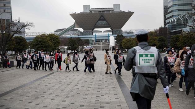Across town, city governor Yuriko Koike convenes an emergency gathering with top officials, fire department, coastguard and self-defence forces. “We have many guests domestically and from abroad for the Tokyo 2020 Games,” she says, wrapping up the meeting. “Please exert your utmost efforts to ensure the safety of spectators and Games workers as much as you do for Tokyo residents,” she orders. (Behrouz Mehri / AFP)