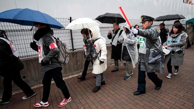 A staff member helps mock evacuees during a simulation disaster drill in Tokyo. The drill, over two locations and involving more than 500 volunteers, was part of Tokyo 2020’s contingency plans as they gear up to host the Games in one of the world’s most seismically active countries. Tokyo firefighters included an anti-terrorism drill alongside emergency preparations in their traditional new year display. (Behrouz Mehri / AFP)