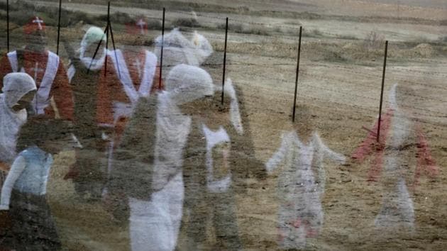 Pilgrims are reflected in a car window as they march towards the Jordan River to participate in a baptism ceremony, near Jericho in the Israeli-occupied West Bank. (Raneen Sawafta / REUTERS) Pilgrims are reflected in a car window as they march towards the Jordan River to participate in a baptism ceremony, near Jericho in the Israeli-occupied West Bank. (Raneen Sawafta / REUTERS)