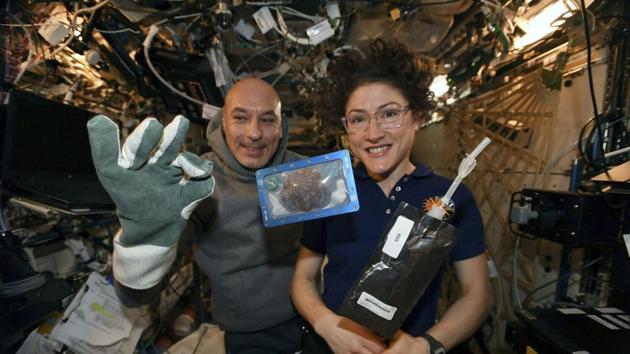 U.S. astronaut Christina Koch and Italian astronaut Luca Parmitano pose for a photo with a cookie. (AP) U.S. astronaut Christina Koch and Italian astronaut Luca Parmitano pose for a photo with a cookie. (AP)