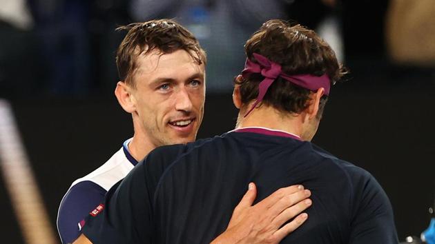 Switzerland's Roger Federer and Australia's John Millman hug each other after their match.(REUTERS)