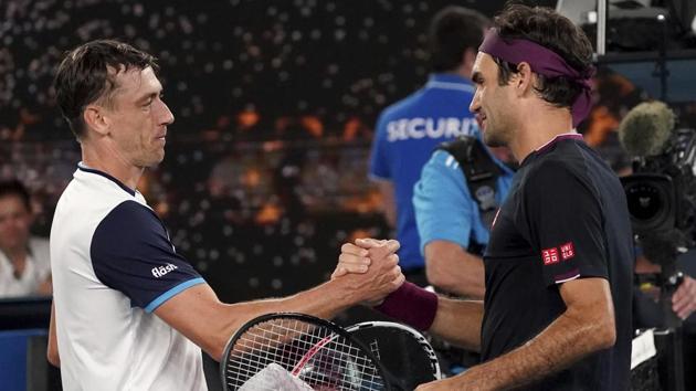 Switzerland's Roger Federer, right, is congratulated by Australia's John Millman.(AP)